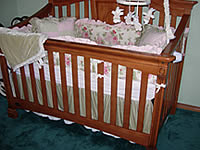 Wooden baby crib with bedding set.